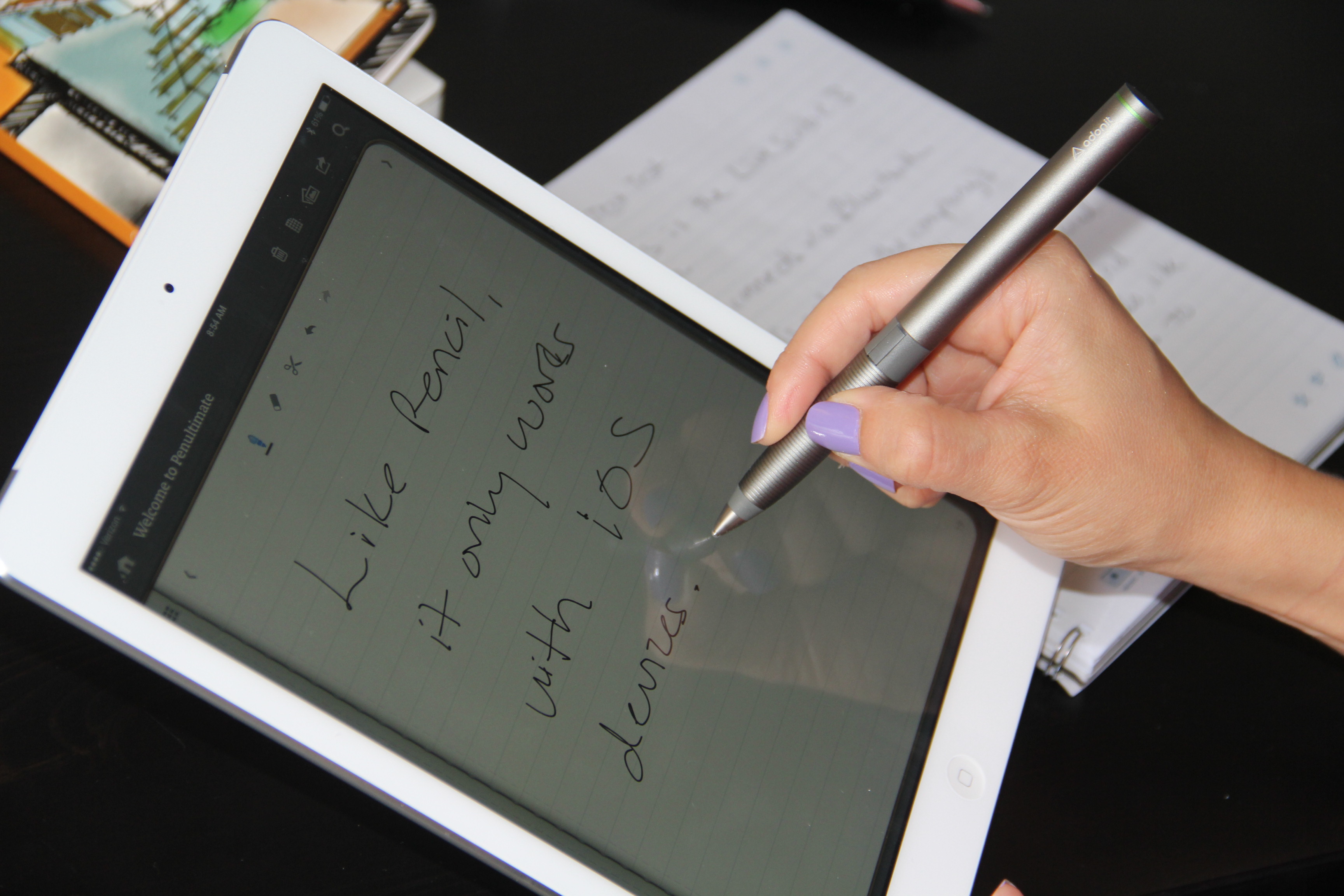  A person using a stylus pen to write on a tablet that is less than 3 million.